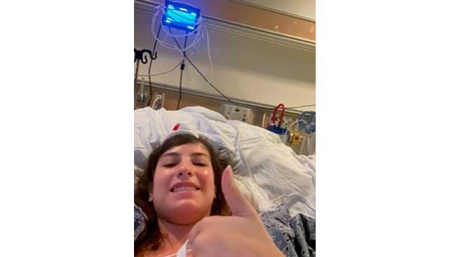 College student Andrea making a silly face during her hospital stay for a minimally invasive craniotomy