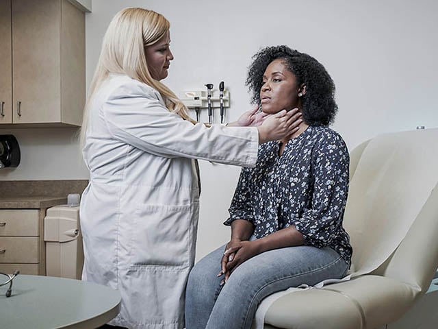 A patient getting a throat exam