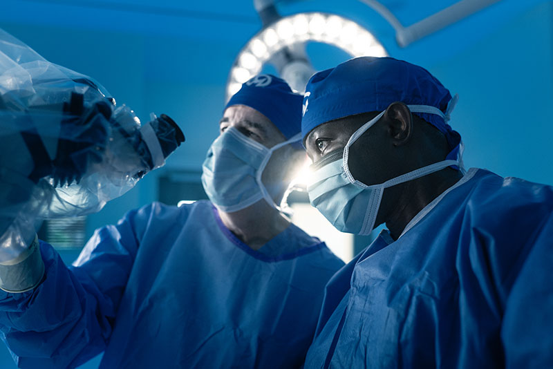 Drs. Vogelbaum and Etame in the operating room