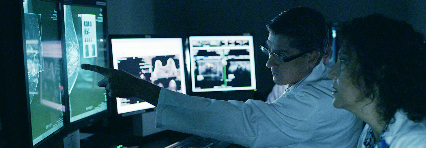 Breast cancer radiologists review a patient's scans
