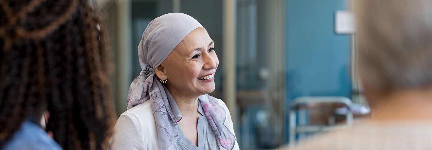 Patient in headscarf consulting with a professional about metastatic breast cancer