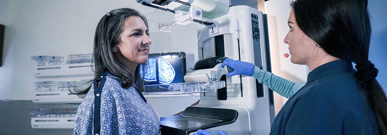 Patient at risk for breast cancer getting a mammogram to increase breast cancer survival rates.