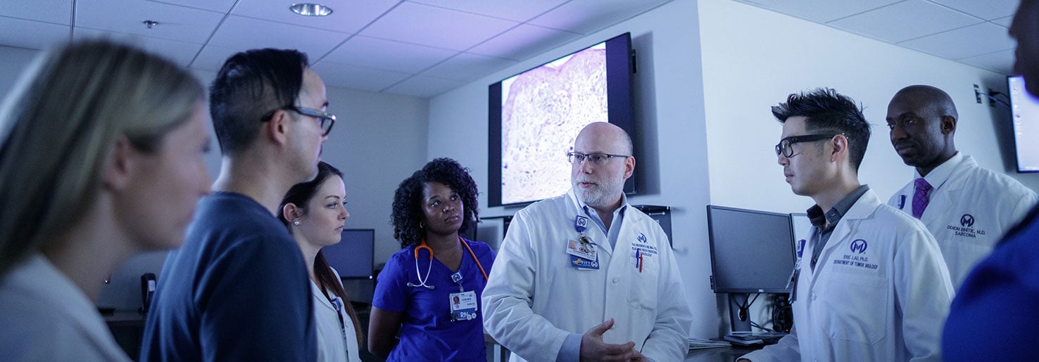 Dr. Trad Wadsworth confers with members of the Head and Neck team