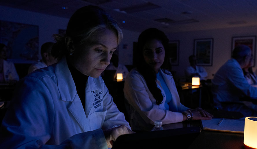 Dr. Caitlin McMullen looks at a screen