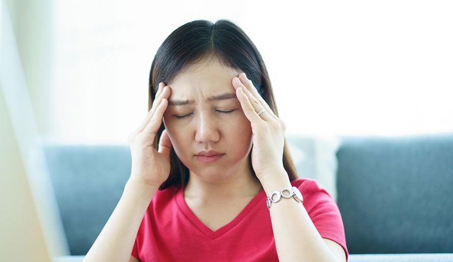 young woman experiencing a headache