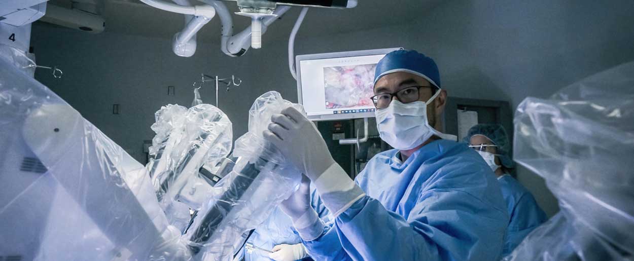 Dr. Roger Lee in the OR performing robotic surgery