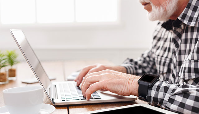 A volunteer typing on a laptop