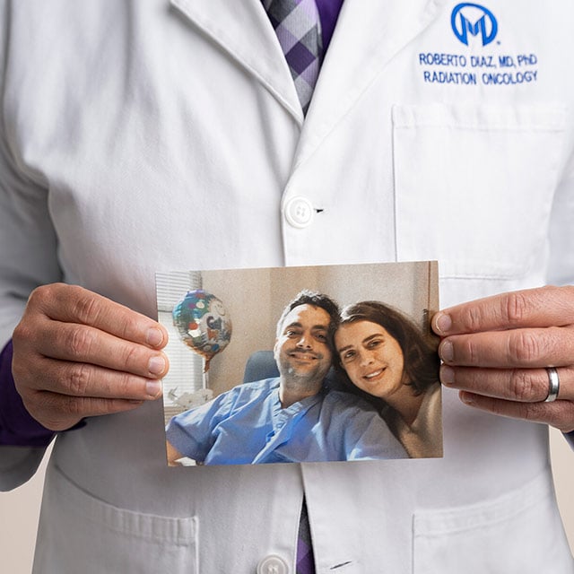 Dr. Diaz with kidney cancer holding a family picture