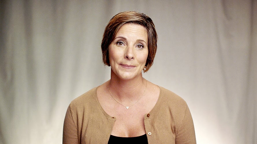 Heather, cervical cancer survivor, wearing a brown cardigan sweater.