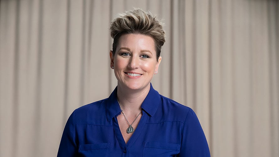 Jessica, metastatic breast cancer survivor, smiles for the camera.