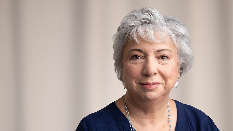 Cervical cancer survivor, Joanne, smiles looking toward the camera.