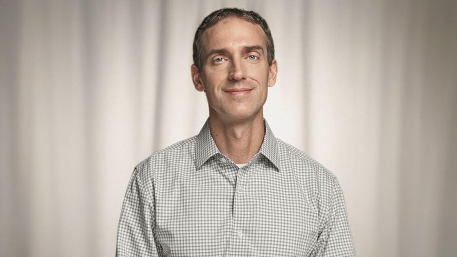 Smiling headshot of John, lymphoma survivor.