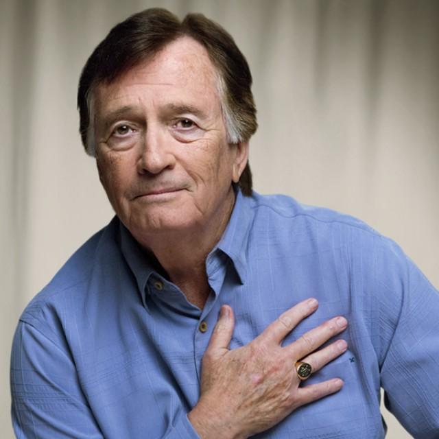 Malcolm, Moffitt volunteer, with his hand over his heart. 