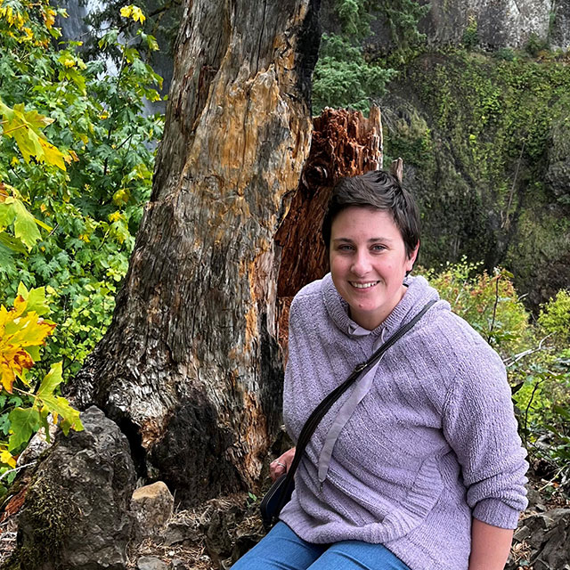 Renee in front of a tree