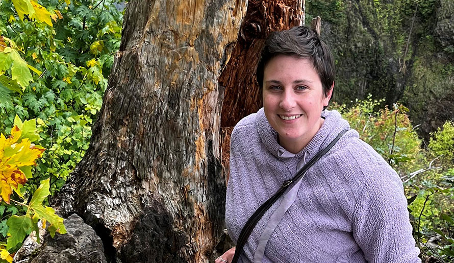 Renee sitting near a tree