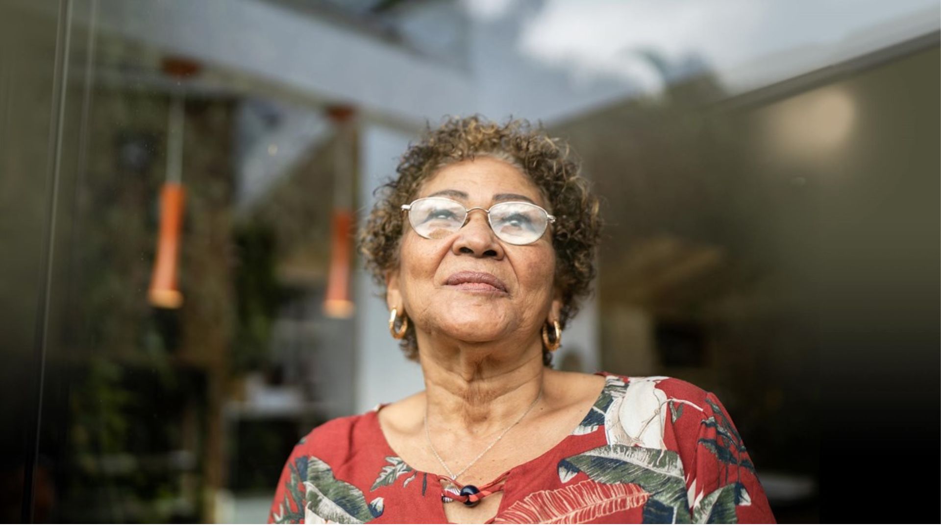Woman stand outside looking at the horizon.