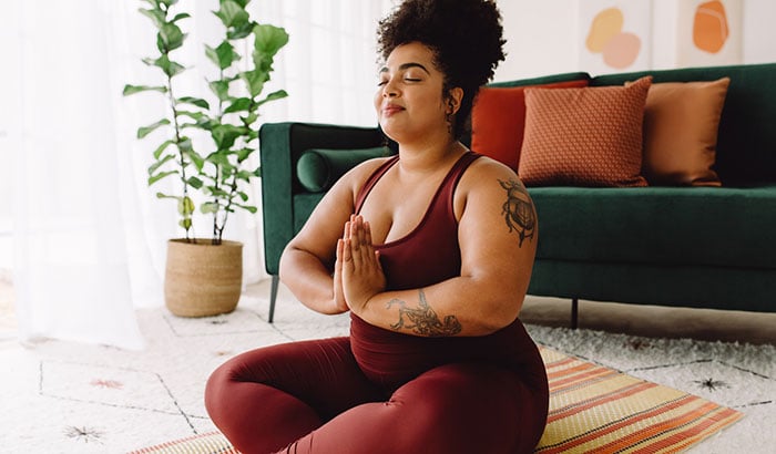 woman doing yoga in living room