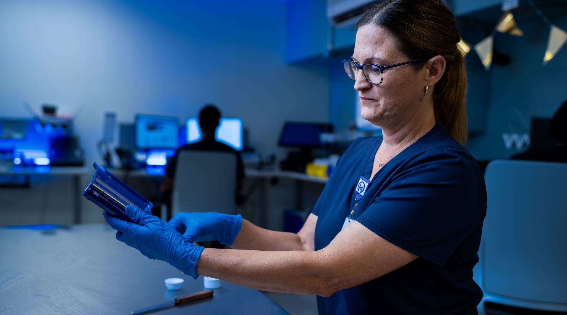 A technician in Specialty Pharmacy measures medication