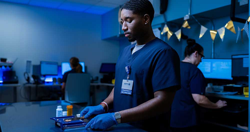 A Specialty Pharmacy technician measures medication