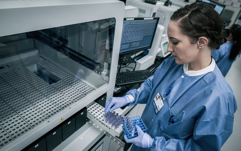 Woman working with test tubes in a lab